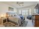 Bright bedroom with bay window, ceiling fan, and ensuite bathroom access at 10356 W Ross Ave, Peoria, AZ 85382