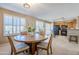 Dining area with round table and chairs, kitchen view at 10356 W Ross Ave, Peoria, AZ 85382