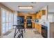 Modern kitchen with black appliances and wood cabinets at 10356 W Ross Ave, Peoria, AZ 85382