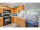 Bright kitchen with wood cabinets, black appliances, and tile flooring at 10356 W Ross Ave, Peoria, AZ 85382