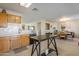 Kitchen with island, wood cabinets, and view of dining area at 10356 W Ross Ave, Peoria, AZ 85382