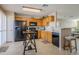 Modern kitchen with black appliances and wood cabinets at 10356 W Ross Ave, Peoria, AZ 85382