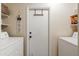 Bright laundry room with washer, dryer, and storage shelves at 10356 W Ross Ave, Peoria, AZ 85382