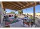 Covered patio with seating area and desert landscaping at 10356 W Ross Ave, Peoria, AZ 85382