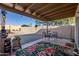 Covered patio with seating area and a tranquil fountain at 10356 W Ross Ave, Peoria, AZ 85382