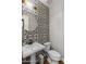 Modern powder room with patterned tile and pedestal sink at 10556 E Relativity Ave, Mesa, AZ 85212