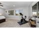 Bedroom with Peloton bike and plenty of natural light at 10556 E Relativity Ave, Mesa, AZ 85212