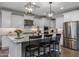 Modern kitchen with white cabinets, granite countertops, and stainless steel appliances at 10556 E Relativity Ave, Mesa, AZ 85212