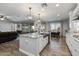 Open kitchen with large island, looking toward living room at 10556 E Relativity Ave, Mesa, AZ 85212