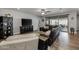 Spacious living room with dark brown leather couches and a large TV at 10556 E Relativity Ave, Mesa, AZ 85212