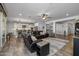 Open concept living room with kitchen view and sliding door to patio at 10556 E Relativity Ave, Mesa, AZ 85212