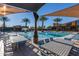 Pool area with tables, chairs, and shade umbrellas at 10556 E Relativity Ave, Mesa, AZ 85212