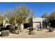 Single-story home with desert landscaping and two-car garage at 11060 E Mark Ln, Scottsdale, AZ 85262