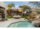 Entertaining backyard with a pool, waterfall, and dining area at 11060 E Mark Ln, Scottsdale, AZ 85262