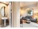 Elegant powder room with a pedestal sink and oval mirror at 11060 E Mark Ln, Scottsdale, AZ 85262