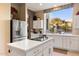 Bright kitchen with island, stainless steel appliances, and white cabinets at 11060 E Mark Ln, Scottsdale, AZ 85262