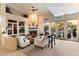 Comfortable living room with a fireplace, built-in shelving, and access to the backyard at 11060 E Mark Ln, Scottsdale, AZ 85262