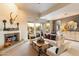 Bright and airy living room featuring a fireplace and access to a backyard patio at 11060 E Mark Ln, Scottsdale, AZ 85262