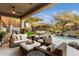 Relaxing covered patio with wicker furniture and ceiling fan at 11060 E Mark Ln, Scottsdale, AZ 85262