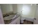 Clean bathroom with granite vanity and bathtub at 11215 W Heatherbrae Dr, Phoenix, AZ 85037