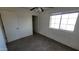 Bright bedroom with ceiling fan, window, and carpet flooring at 11215 W Heatherbrae Dr, Phoenix, AZ 85037