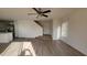 Living area with laminate floors and kitchen view at 11215 W Heatherbrae Dr, Phoenix, AZ 85037