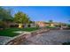 Landscaped backyard with stone pathways and a grassy area at 12824 E Jenan Dr, Scottsdale, AZ 85259