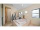 Bathroom with soaking tub and glass block shower at 12824 E Jenan Dr, Scottsdale, AZ 85259