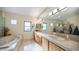 Large bathroom with double sinks, soaking tub, and glass-block shower at 12824 E Jenan Dr, Scottsdale, AZ 85259