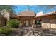 Home's entrance with covered walkway and desert landscaping at 12824 E Jenan Dr, Scottsdale, AZ 85259