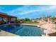 Relaxing pool with waterfall feature and patio space at 12824 E Jenan Dr, Scottsdale, AZ 85259