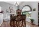 Bright dining room with wood table and chairs, and arched window at 1313 W Glenmere Dr, Chandler, AZ 85224