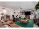 Living room with built-in shelving, fireplace, and green carpet at 1313 W Glenmere Dr, Chandler, AZ 85224