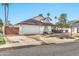 House exterior showcasing a well-maintained front yard and a two-car garage at 13232 N 54Th Dr, Glendale, AZ 85304