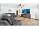 Relaxing living room featuring leather furniture and a large flatscreen TV at 13232 N 54Th Dr, Glendale, AZ 85304