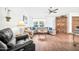 Living room featuring a comfortable sectional sofa, wood floors, and a built-in cabinet at 13232 N 54Th Dr, Glendale, AZ 85304