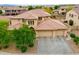 Two-story house with three car garage, landscaped yard, and mountain views at 15296 W Coolidge St, Goodyear, AZ 85395