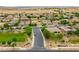 Aerial view of a residential neighborhood with parks and open space at 15296 W Coolidge St, Goodyear, AZ 85395