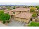 Two-story house with three car garage and desert landscape at 15296 W Coolidge St, Goodyear, AZ 85395