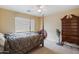 Bedroom with a queen bed, dresser, and ceiling fan at 15296 W Coolidge St, Goodyear, AZ 85395