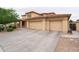 Two-story house with three-car garage and landscaped yard at 15296 W Coolidge St, Goodyear, AZ 85395