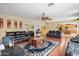 Spacious living room with hardwood floors, and a view into the kitchen at 15296 W Coolidge St, Goodyear, AZ 85395