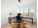 Bright home office with large window, L-shaped desk, and cowhide rug at 16328 E Ridgeline Dr, Fountain Hills, AZ 85268