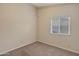 Simple bedroom featuring neutral walls, carpet flooring, and window with blinds at 1638 E Sandra Ter, Phoenix, AZ 85022