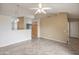 Open-concept living room featuring tile floors, ceiling fan, and easy access to the kitchen at 1638 E Sandra Ter, Phoenix, AZ 85022