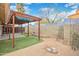 Backyard with shaded patio and synthetic grass at 1638 E Sandra Ter, Phoenix, AZ 85022