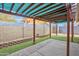 Covered patio in the backyard with synthetic grass and wall at 1638 E Sandra Ter, Phoenix, AZ 85022