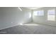 Bright bedroom with carpeted floor and windows at 1645 W Baseline Rd # 2075, Mesa, AZ 85202