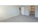 Bedroom with gray carpet, built in shelving, and a door at 1645 W Baseline Rd # 2075, Mesa, AZ 85202