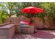 Outdoor kitchen area with a built-in grill and sitting area at 16636 S 34Th Way, Phoenix, AZ 85048